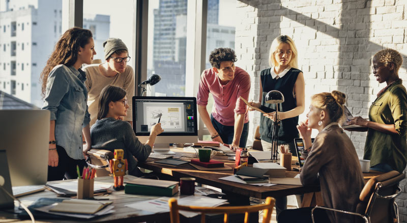 People huddled around a desk