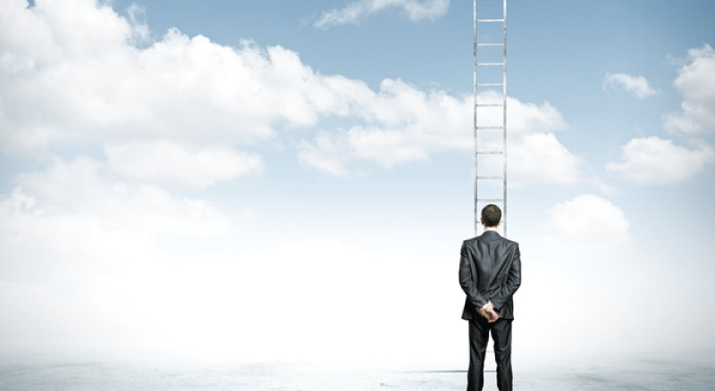 Man looking at clouds with ladder