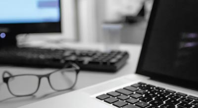 Laptop and glasses on desk