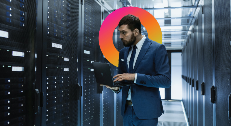 Man in data center on laptop