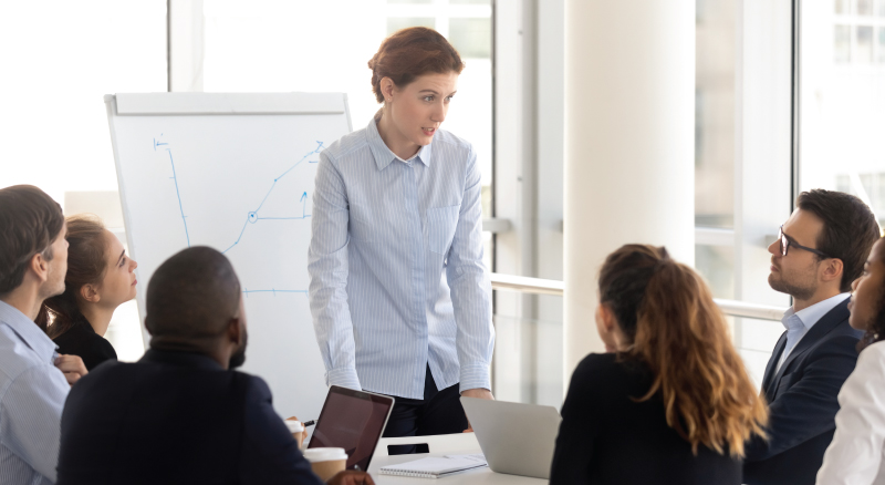 Woman leading a meeting and discussing things with team members