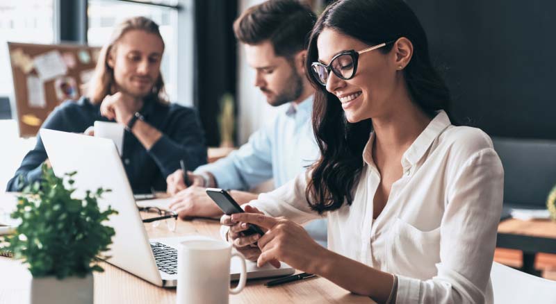 Women Using Phone and Laptop