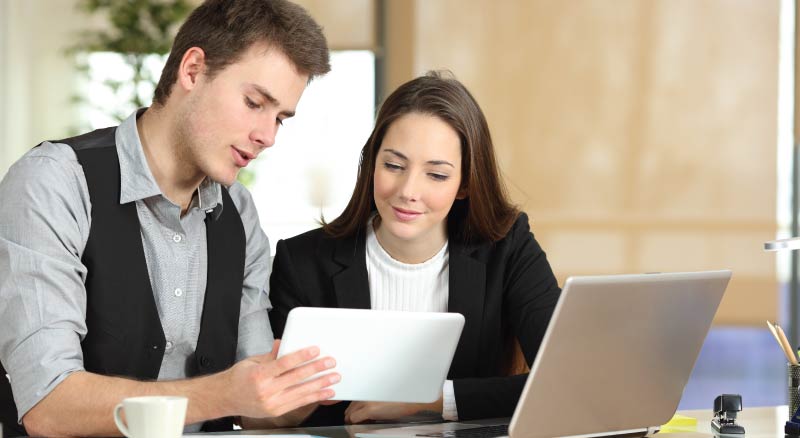 Man and woman on tablet and computer