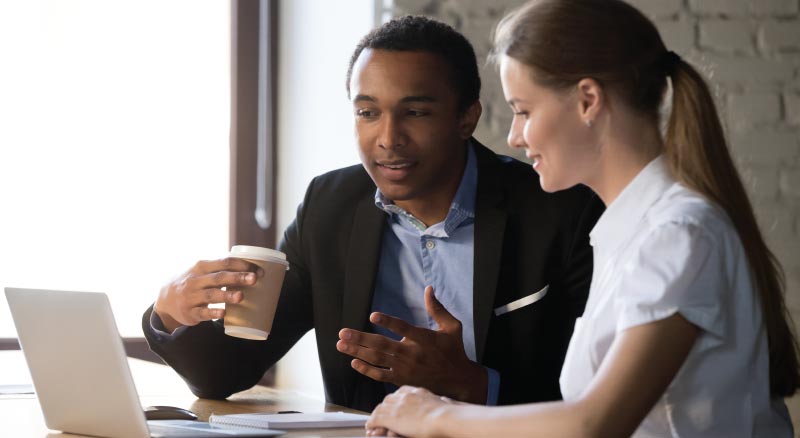 Man and woman infront of laptop talking