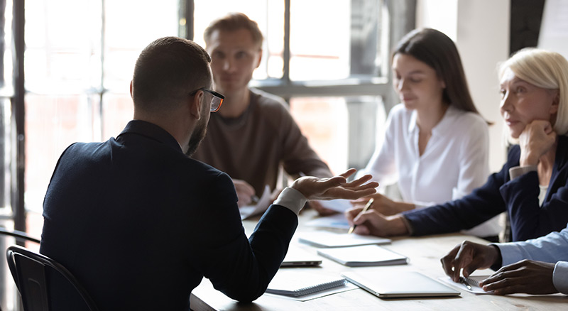Employees meeting around a table in a modern office environment