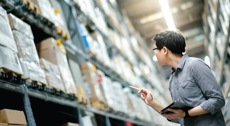 Man going over inventory in warehouse