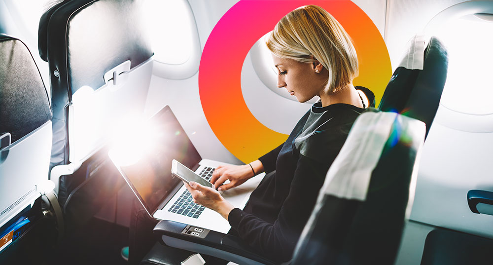 Woman on airplane accessing her devices identiy and access management