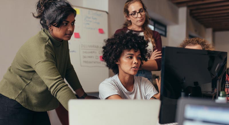 People Huddled Around Computer