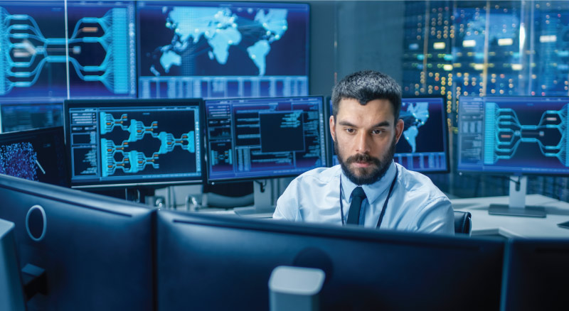 Young female programer working on desktop in data center room