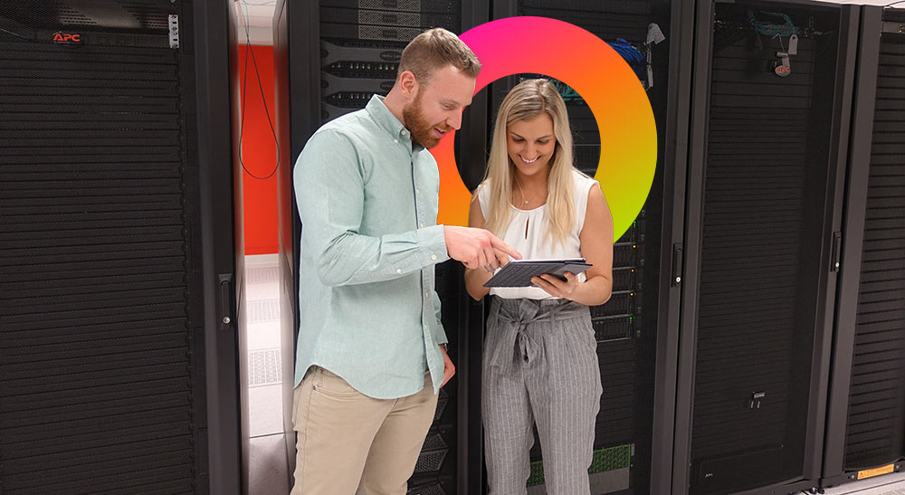 Employees looking at template in server room