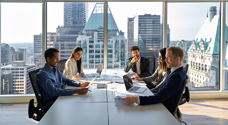 Multiple people having a team meeting in an office setting
