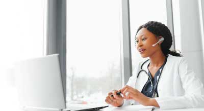 Female doctor on phone and computer