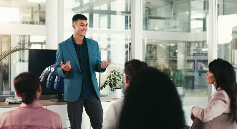 A speaker addresses a group, sharing insights during a professional presentation.