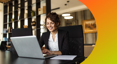 An individual using a laptop in a modern office