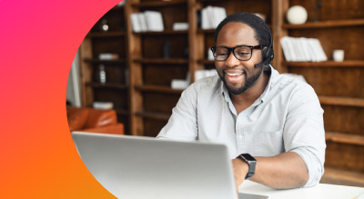 An individual is sitting at a desk with a laptop