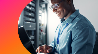An employee on a laptop in a data center