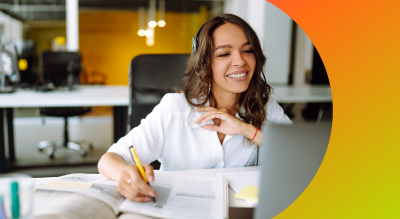 A student with headphones smiling while on a call on apple device