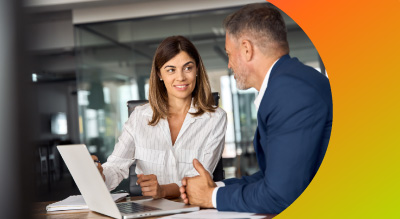 Two employees working on mac devices