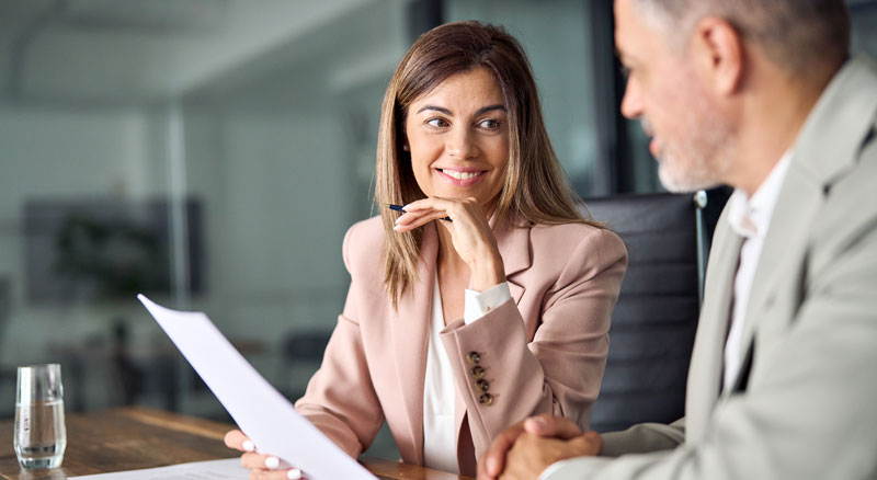 TTwo individuals reviewing a contract