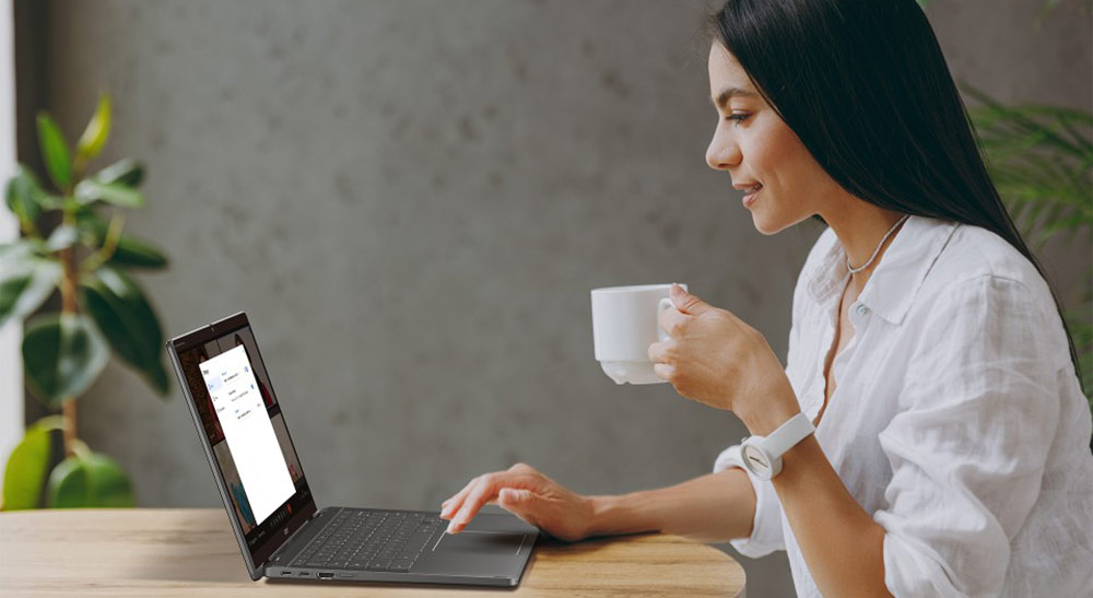 Coworkers looking at two desktop screens