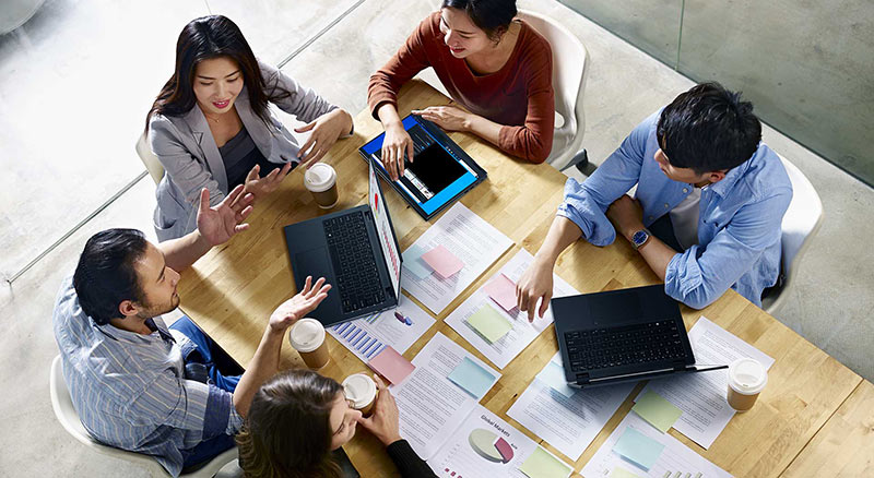 employees using acer laptops on desk