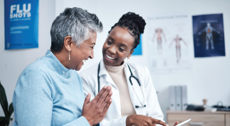 Healthcare professional in a clinic discussing medical information with a patient