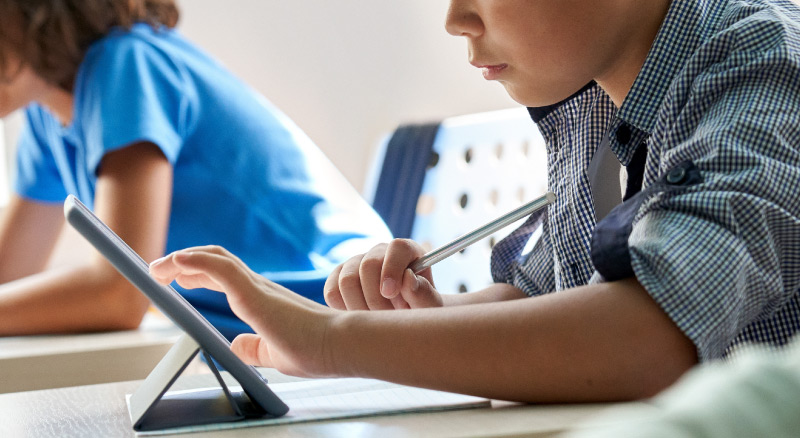 Child using tablet in classroom