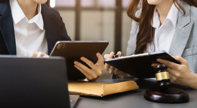 Two woman holding ipads