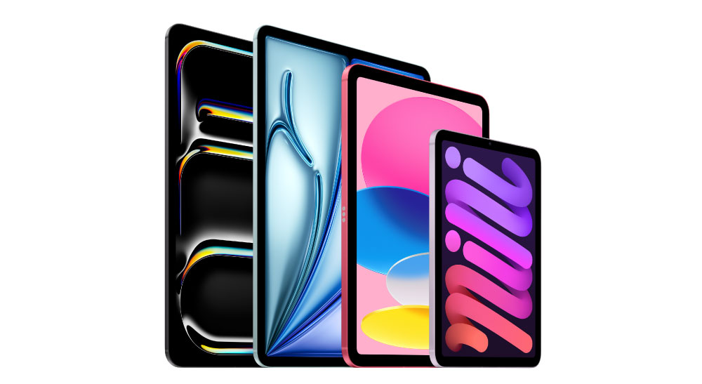 Four tablet devices of varying sizes are displayed standing upright side by side, each showing a colorful screen