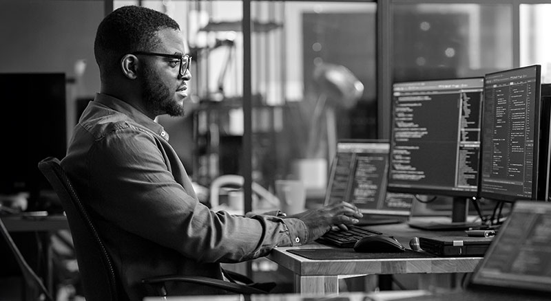 Man typing code on computer