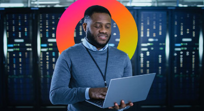 Man looking at laptop in data center
