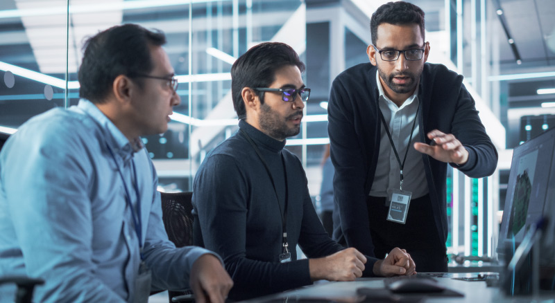 Three people working together on computer