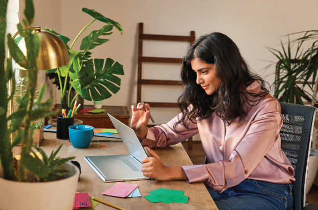 Woman in office on laptop working