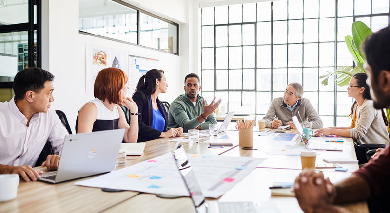 Multiple individuals in an indepth conversation during an office meeting