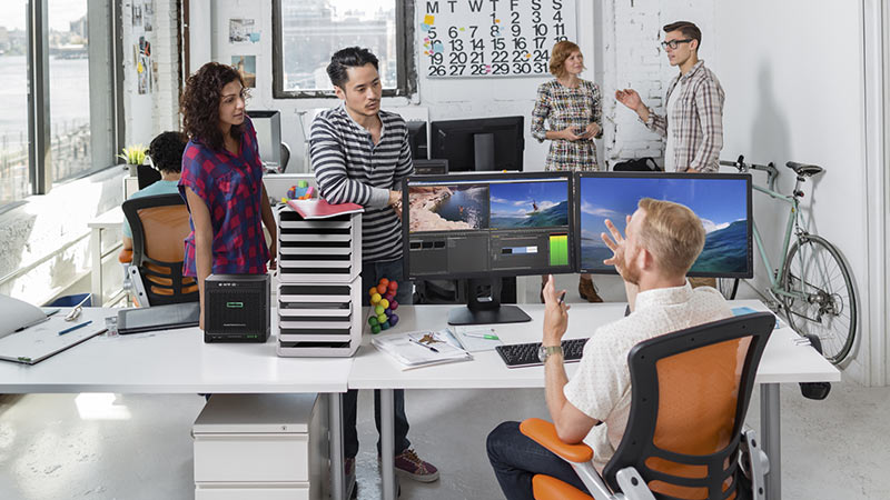 Group of employees huddled in room talking