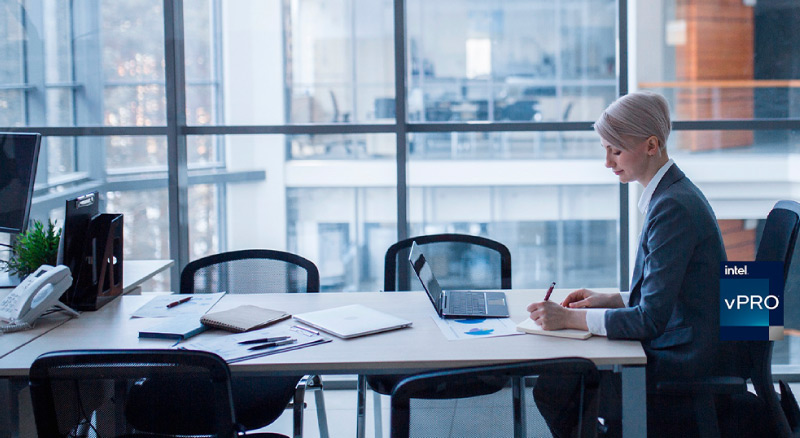 Woman working in her office with laptop infront of her