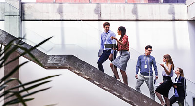 Office workers walking up a staircase