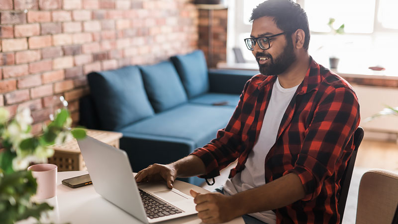 Man uses laptop in casual environment