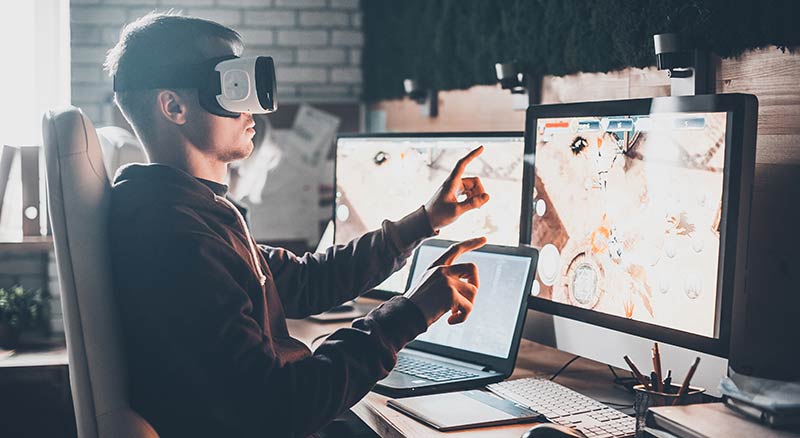 Employee using virtual reality headset to train and work with team