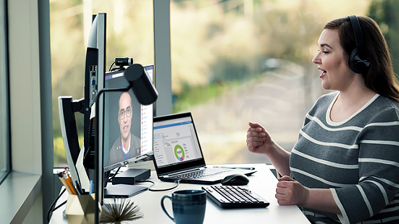 Woman remotely holds conference and talks to her web camera