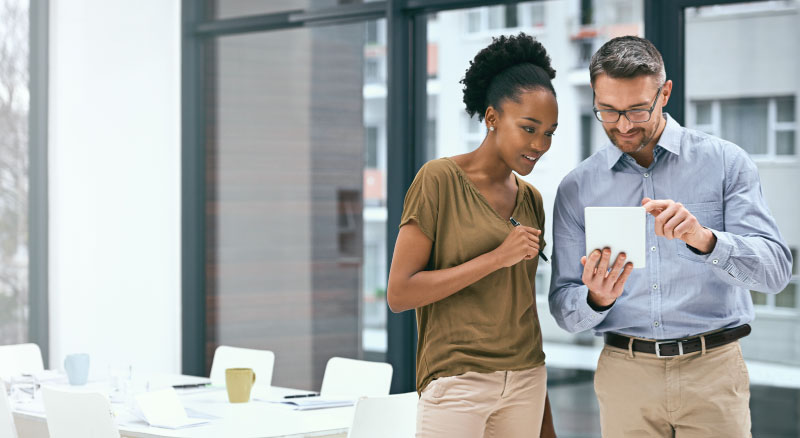 Two people working together on a ipad