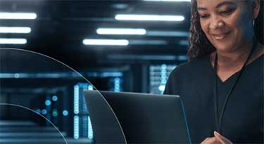 woman holding laptop in hands in a server room