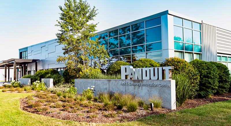 Exterior view of the Panduit Jack E. Caveney Innovation Center building with landscaped greenery in the foreground