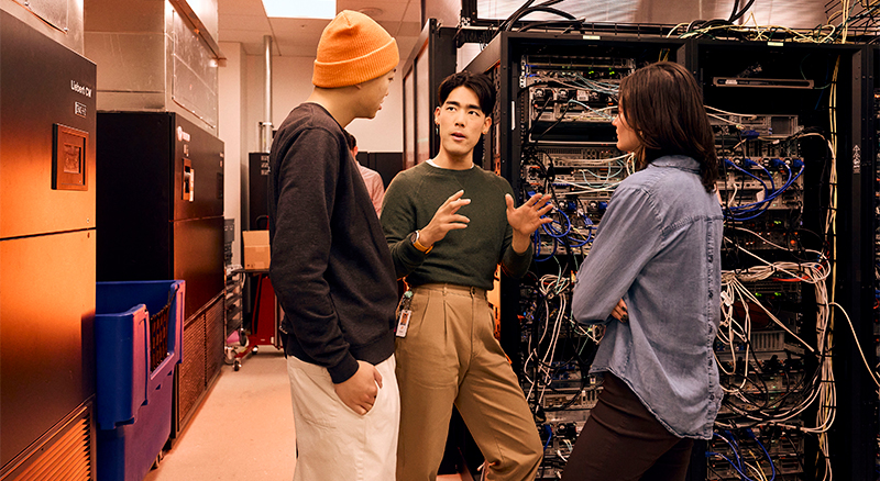 Employees talking in a server room