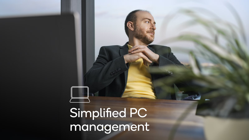 An employee reclining on a chair with overlaying text displayinging 'simplified PC management'