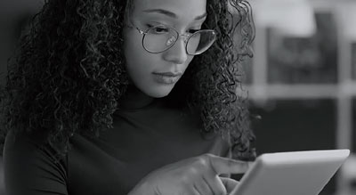 Woman with glasses uses tablet