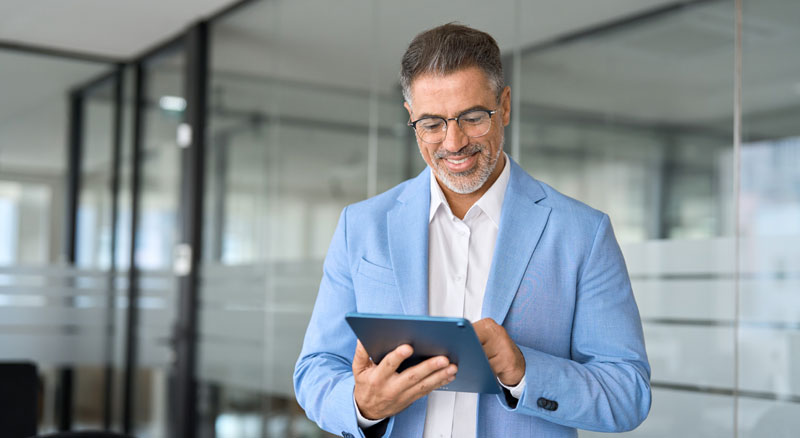 A person using a digital tablet while standing in an office