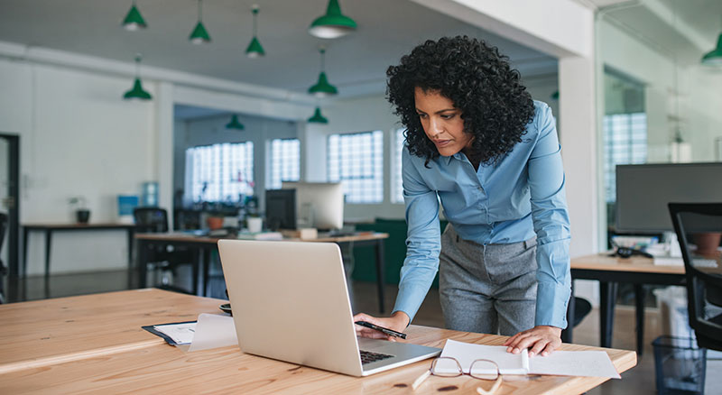Woman types on laptop