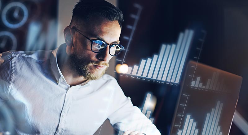 IT specialist focused with holographic UI in the background