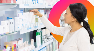 A person reaching for a product on a brightly lit store shelf